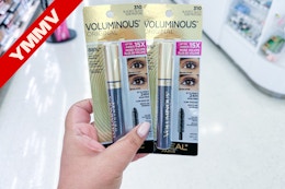 hand holding two mascaras with ymmv banner