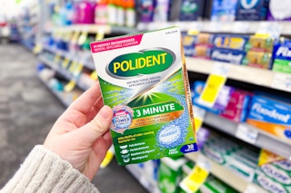person holding polident retainer cleaner tablets