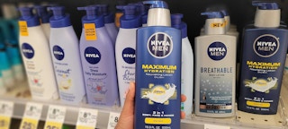 bottle of nivea men lotion held in front of nivea lotion bottles on shelf