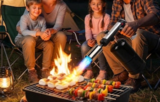 a person using a torch on a grill outside