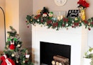 Christmas garland on a mantle next to a Christmas tree