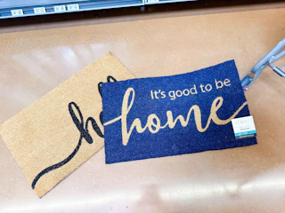 two mainstays coir doormats on walmart floor next to cart