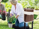 a woman kneeling on a seating while gardening with a man 
