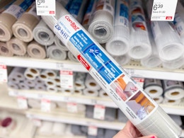 hand holding contact shelf and drawer liner in front of others on target shelf