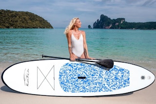 a woman near a stand up paddleboard