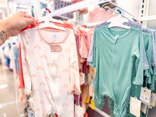 hand holding a 2 pack of cloud island sleep & plays