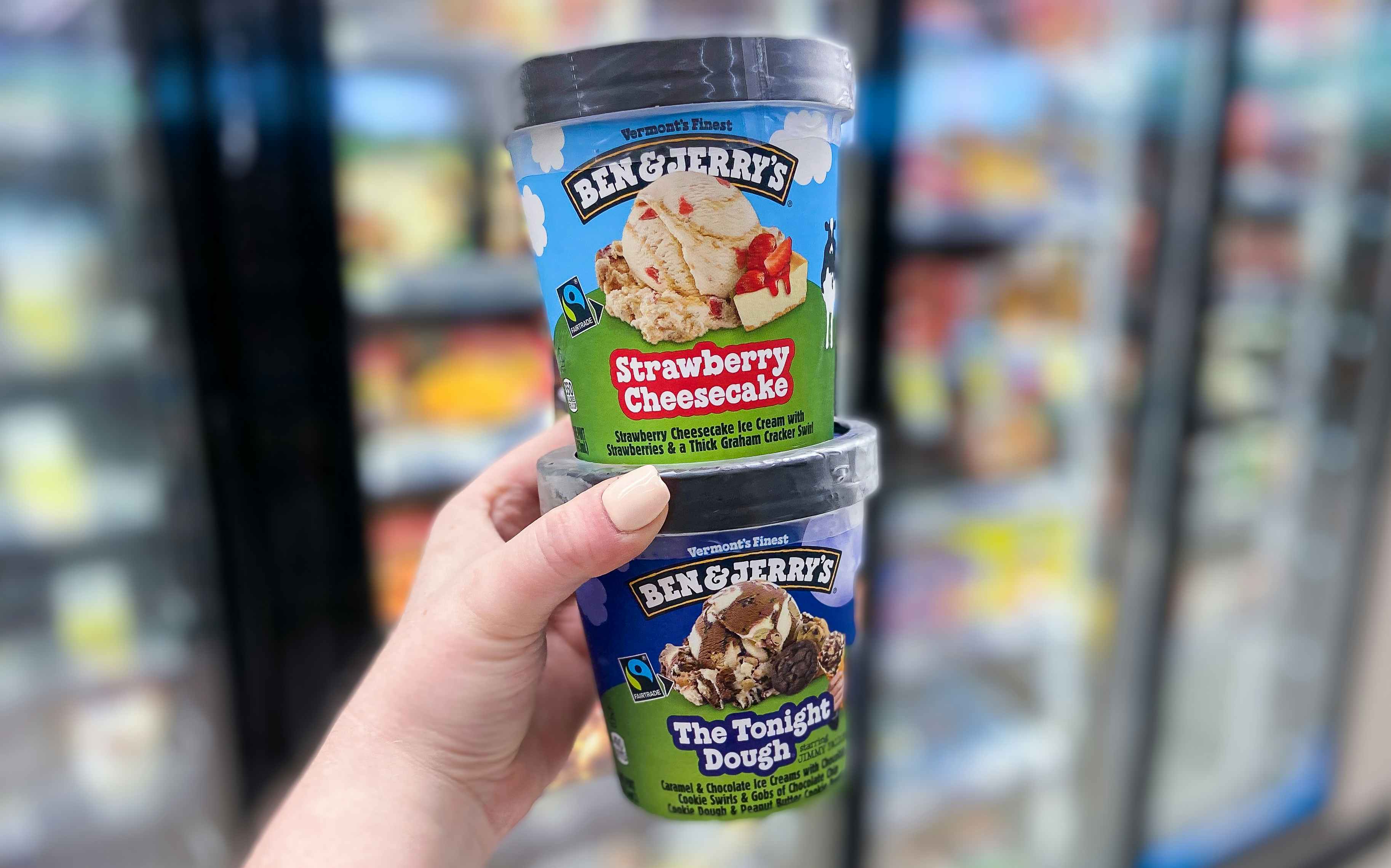 hand holding two pints of ben & jerry's ice cream