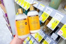 person holding 2 bottles of shea moisture shampoo and conditioner