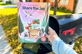 amazon kids gift book being held in front of mailbox 