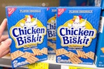 hand touching a box of chicken in a biskit crackers