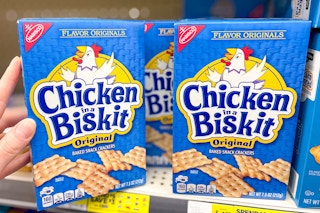 hand touching a box of chicken in a biskit crackers