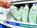 hand holding a bottle of head & shoulders bare shampoo on walmart shelf