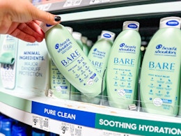 hand holding a bottle of head & shoulders bare shampoo on walmart shelf