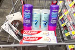 covergirl, aussie, degree, and colgate products in a cart