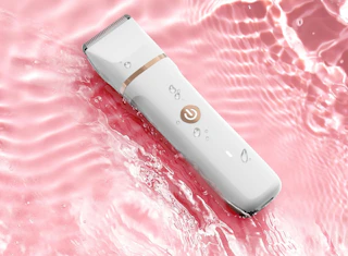 a bikini trimmer on a pink background with water