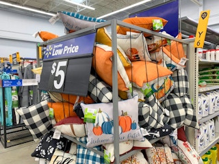 fall and autumn outdoor throw pillows in a large bin