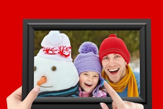 a hand holding a digital picture frame