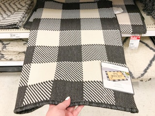 hand grabbing a threshold scatter rug at target