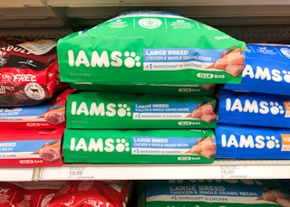 three bags of Iams dog food stacked on store shelf