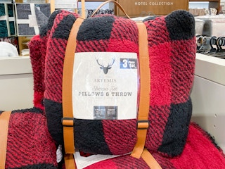a throw blanket and pillow set in red and black plaid
