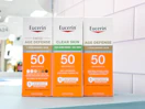 3 eucerin sun sitting on a table by a target aisle