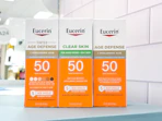 3 eucerin sun sitting on a table by a target aisle