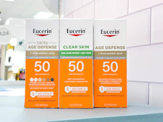 3 eucerin sun sitting on a table by a target aisle