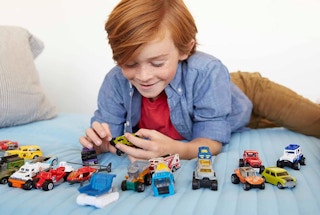 a boy playing with toy cars