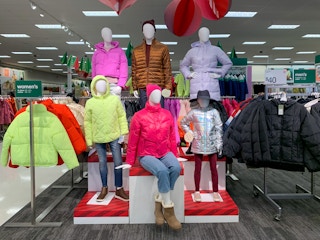 a display of mannikins inside Target wearing puffer jackets