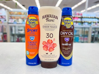 Hawaiian tropic and banana boat sunscreens on a counter in walgreens