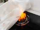 a blanket covering a stove fire