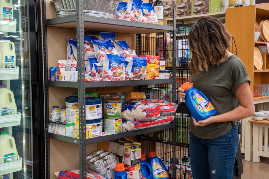 woman comparing products near endcap in store