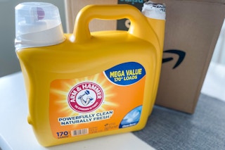 a yellow detergent bottle in front of an Amazon box