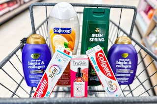 ogx shampoo, softsoap and irish spring body wash, truskin serum, and colgate toothpastes in a cart