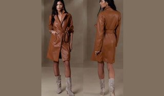 a woman wearing a long vegan leather jacket