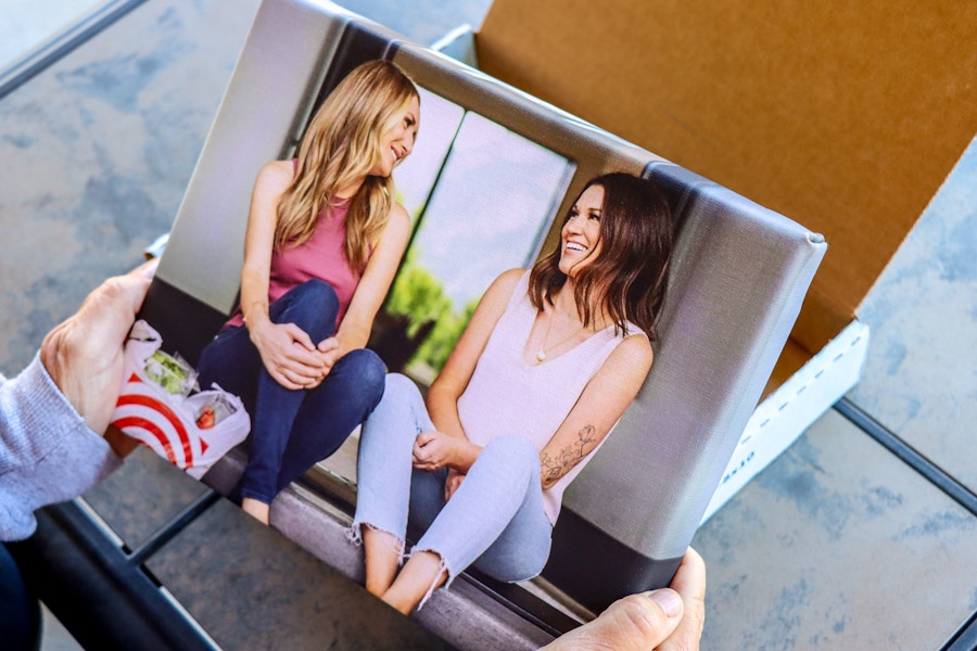 a person holding a Walgreens Photo canvas.