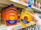 hand holding softsoap refill next to another on walmart shelf