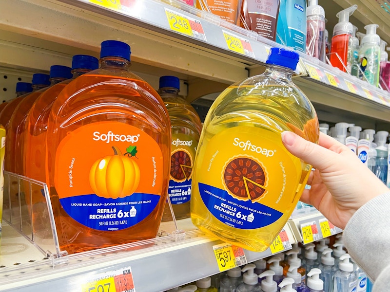hand holding softsoap refill next to another on walmart shelf