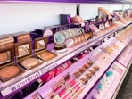 A view down the aisle of the Tarte brand makeup section inside Sephora.