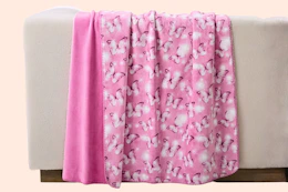 Paris Hilton Butterflies Reversible Throw Blanket over the back of furniture