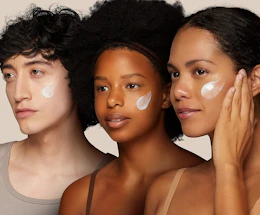 three people with retinol cream on their faces