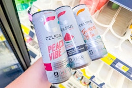 hand holding celsius drinks at dollar general