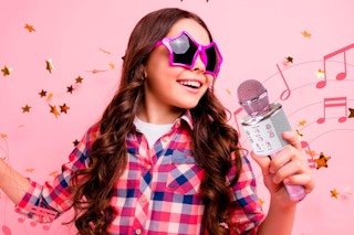 kid singing with the Claire's Karaoke Microphone