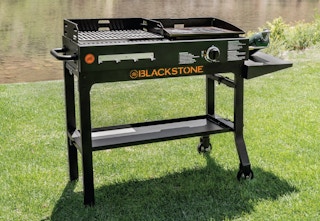 a black Blackstone duo grill and griddle in the grass