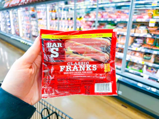 hand holding a pack of bar-s franks