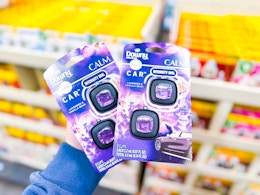 2 Febreze Air Freshener Car Vent Clips being held up in Walmart store