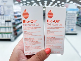 a hand holding two boxes with orange writing