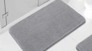 a grey chenille rug in a bathroom