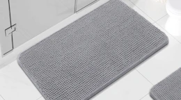 a grey chenille rug in a bathroom
