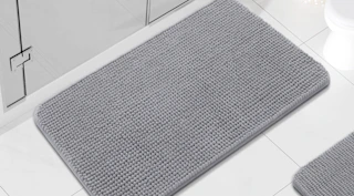 a grey chenille rug in a bathroom